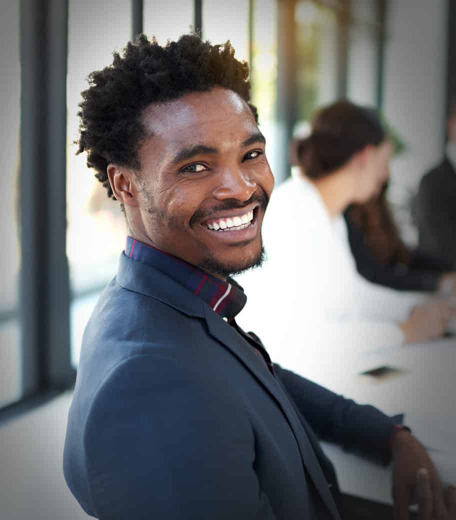 Photo of man in a suit smiling